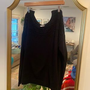 Sweater with cut out pattern at top